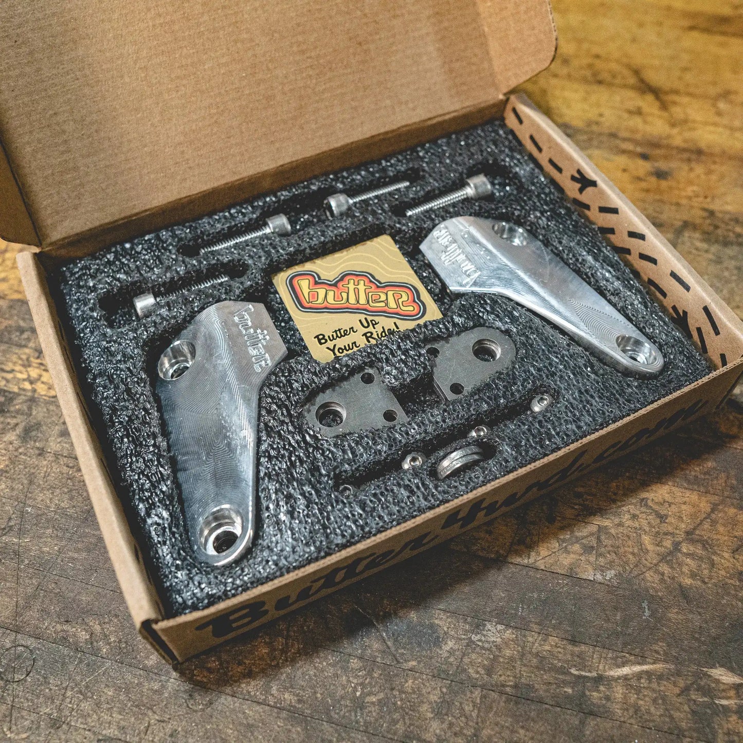 Boxed hardware kit with metal components inside.