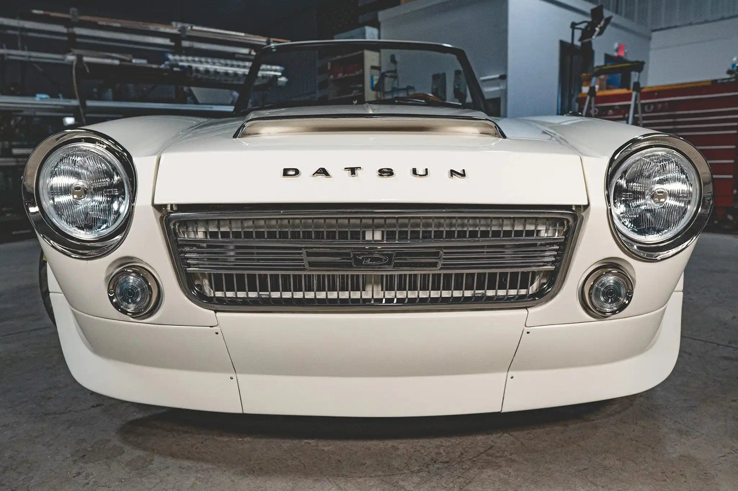 Front view of a classic white Datsun 2000 roadster.